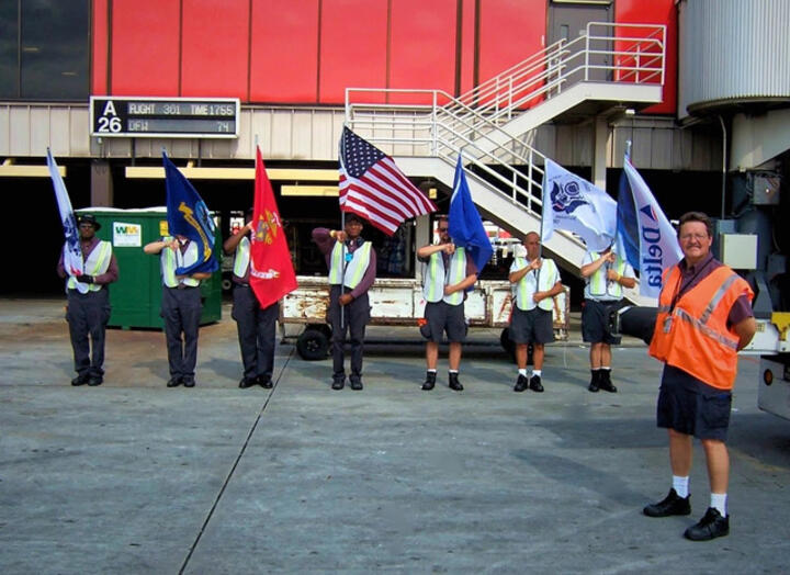 Honor Guard members standing in line with flags