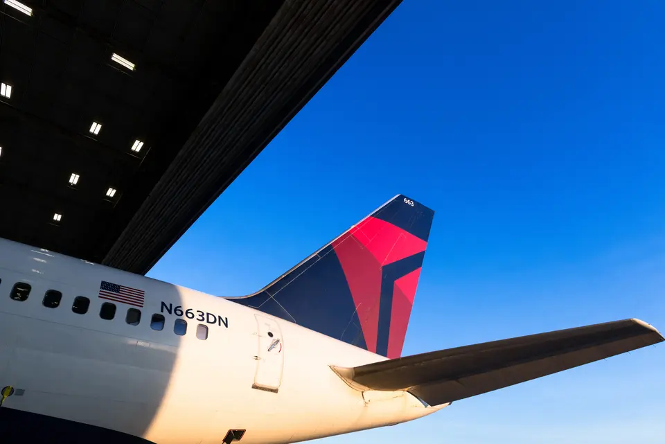 Tail of a 757-200 in an airport hangar