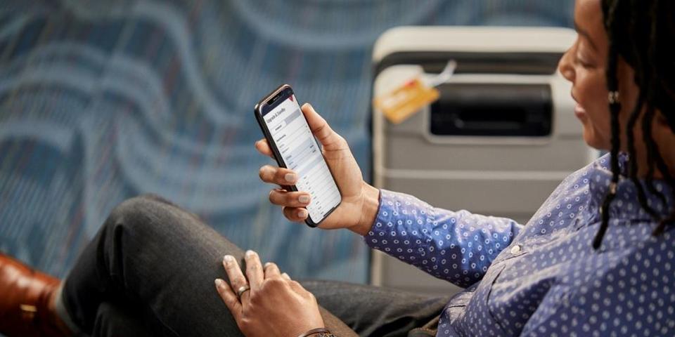 A Delta customer uses the Fly Delta app to view their flight.