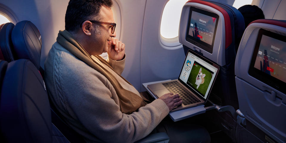 A customer enjoys surfing the web using Delta's fast, free Wi-Fi powered by T-Mobile.