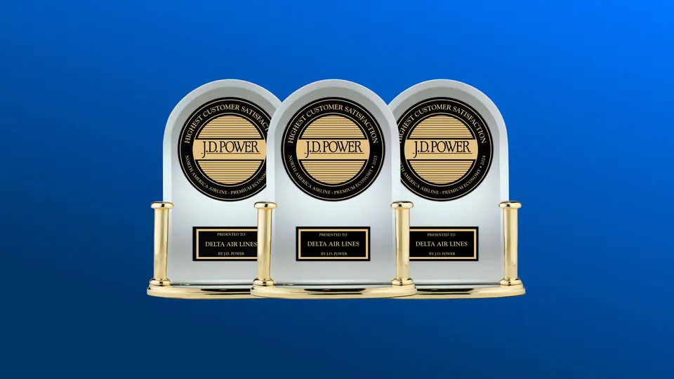 Three J.D. Power trophies against a blue background