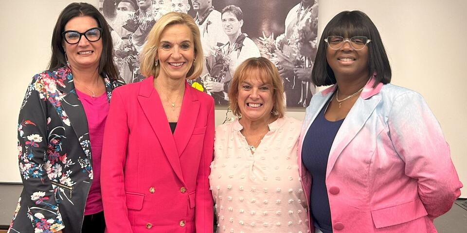 EVP and Chief People Officer Allison Ausband posing with three Delta employee breast cancer survivors.