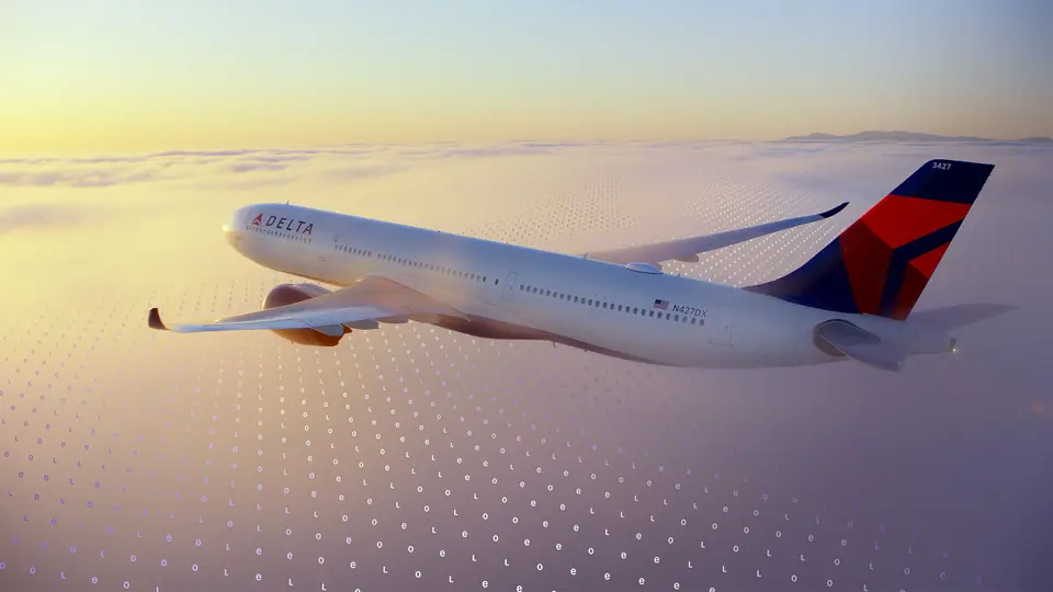 A Delta jet flies above a cloud layer at sunset, with a faint digital grid pattern overlaid across the sky.