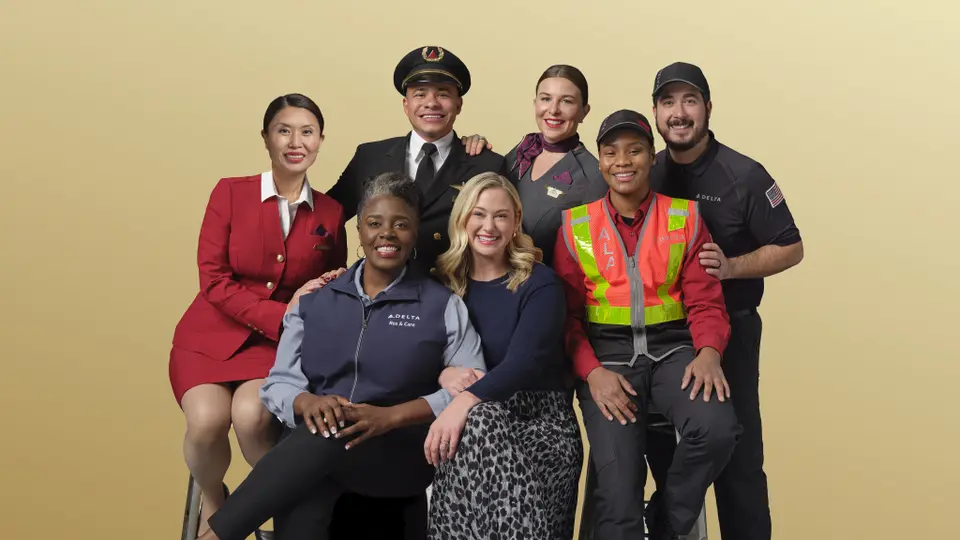 Delta people from across the airline's business pose in this 2024 photo.