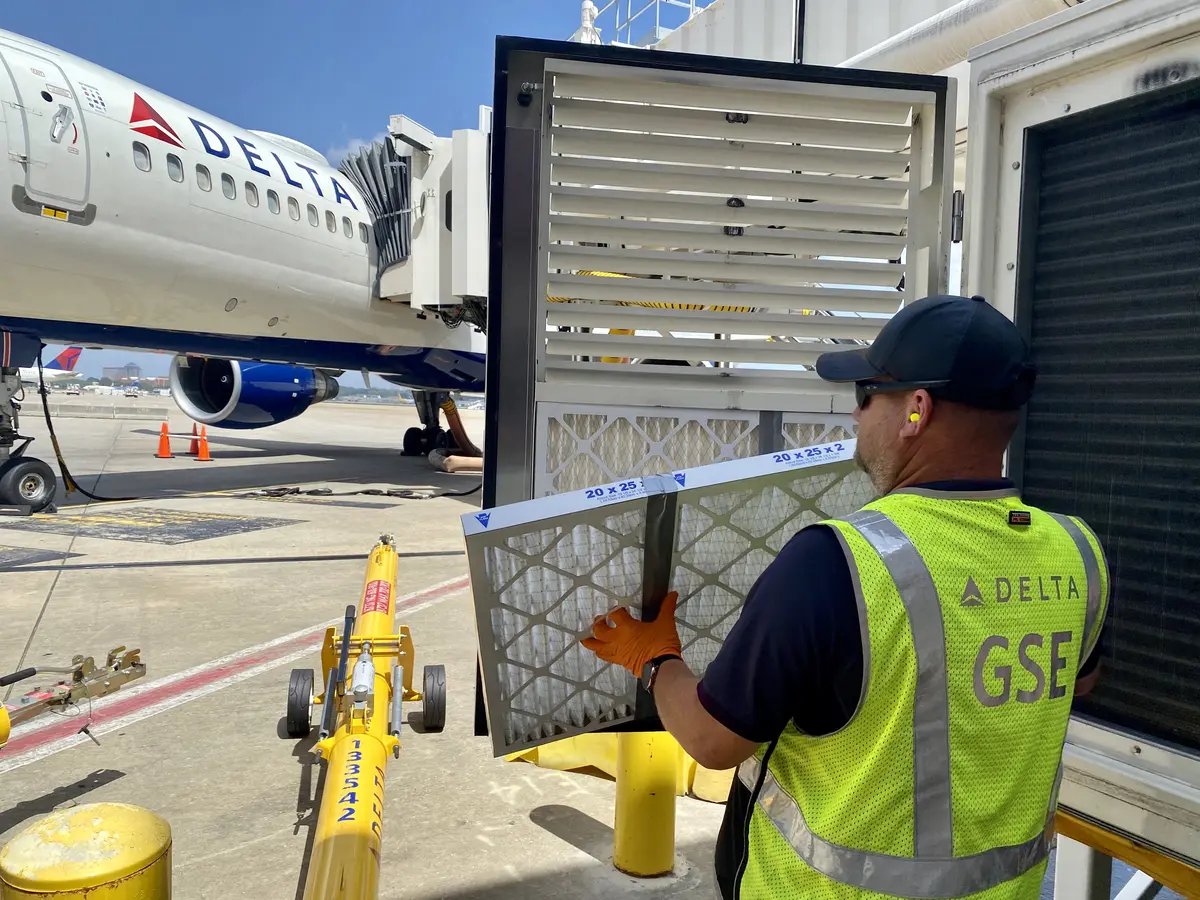 GSE employee installing air filter
