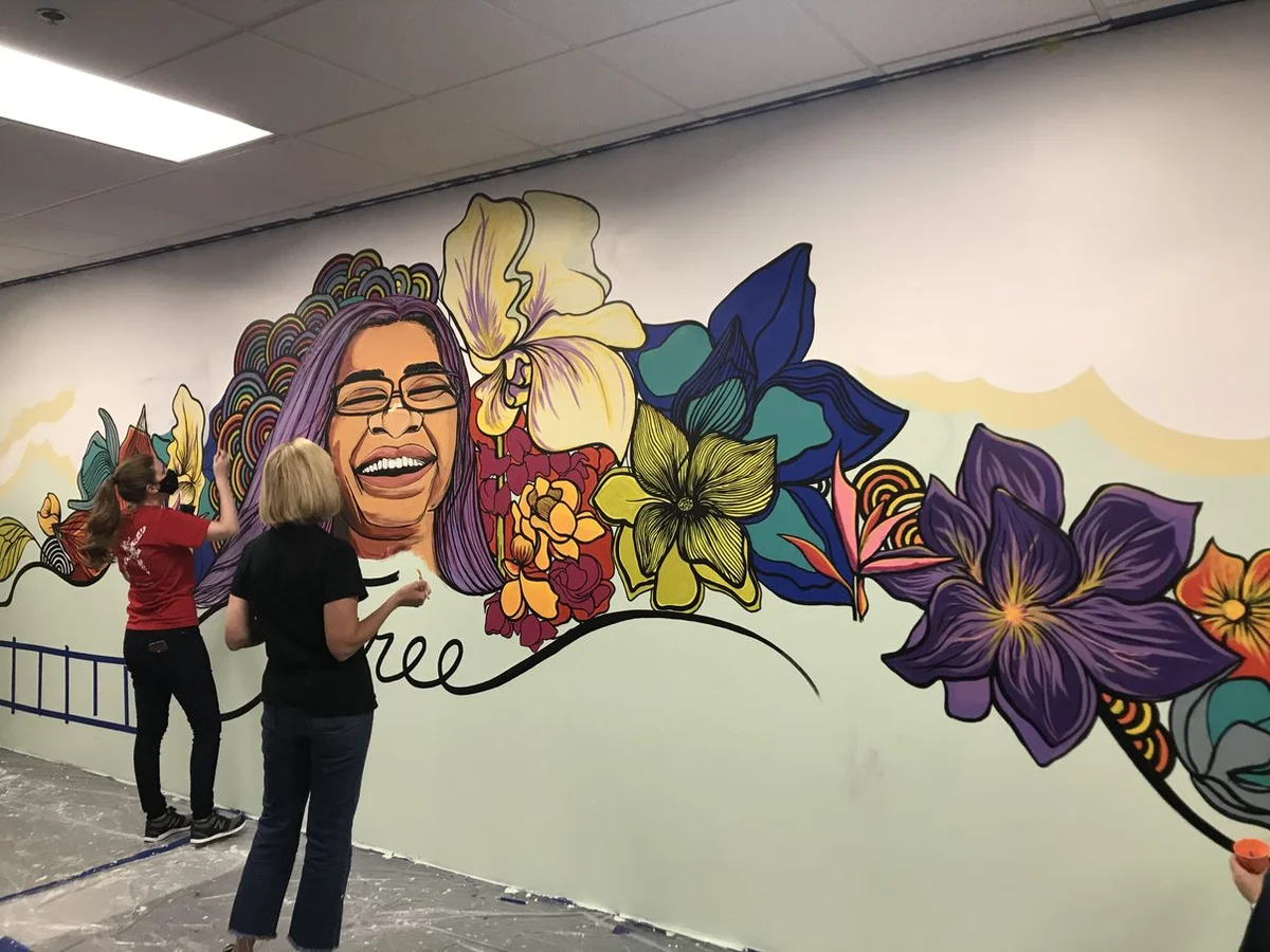 Allison Ausband and Delta volunteers painting the mural.