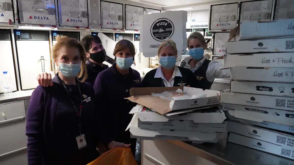 Delta Air Lines Flight Attendant serves passengers during CRAF mission.