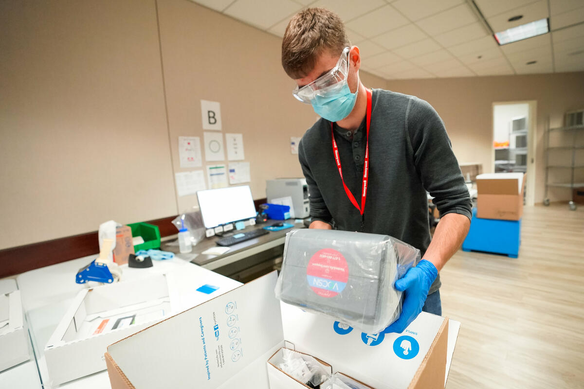 A GM employee works on a ventilator.