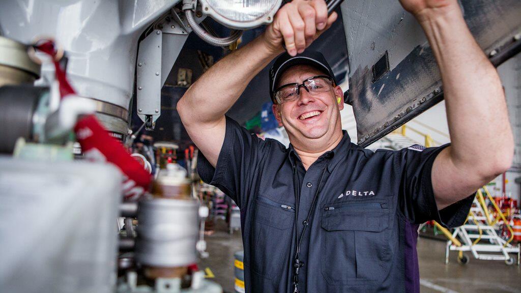 A Delta mechanic works on a plane.