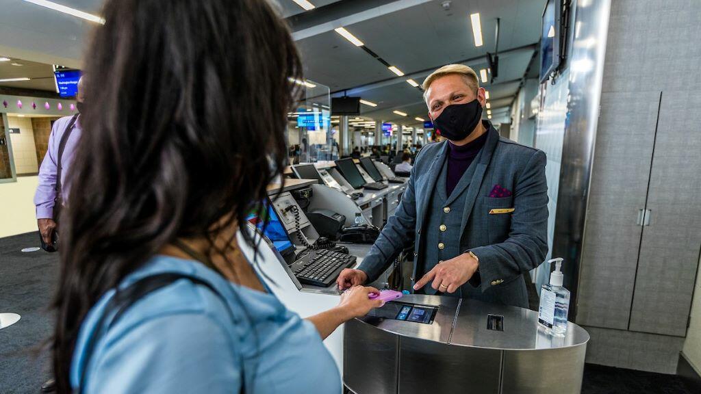 A passenger boards a flight using a mobile boarding pass.