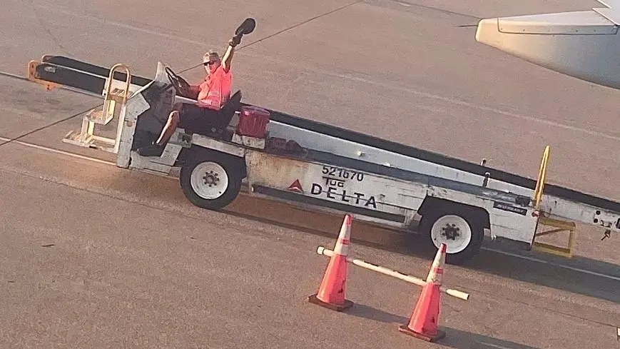 Delta ramp agent Greg Kaufmann waves farewell to his daughter Adrienne.