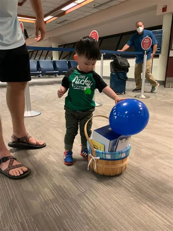 Beau checks out the balloons given to him by the Delta staff.