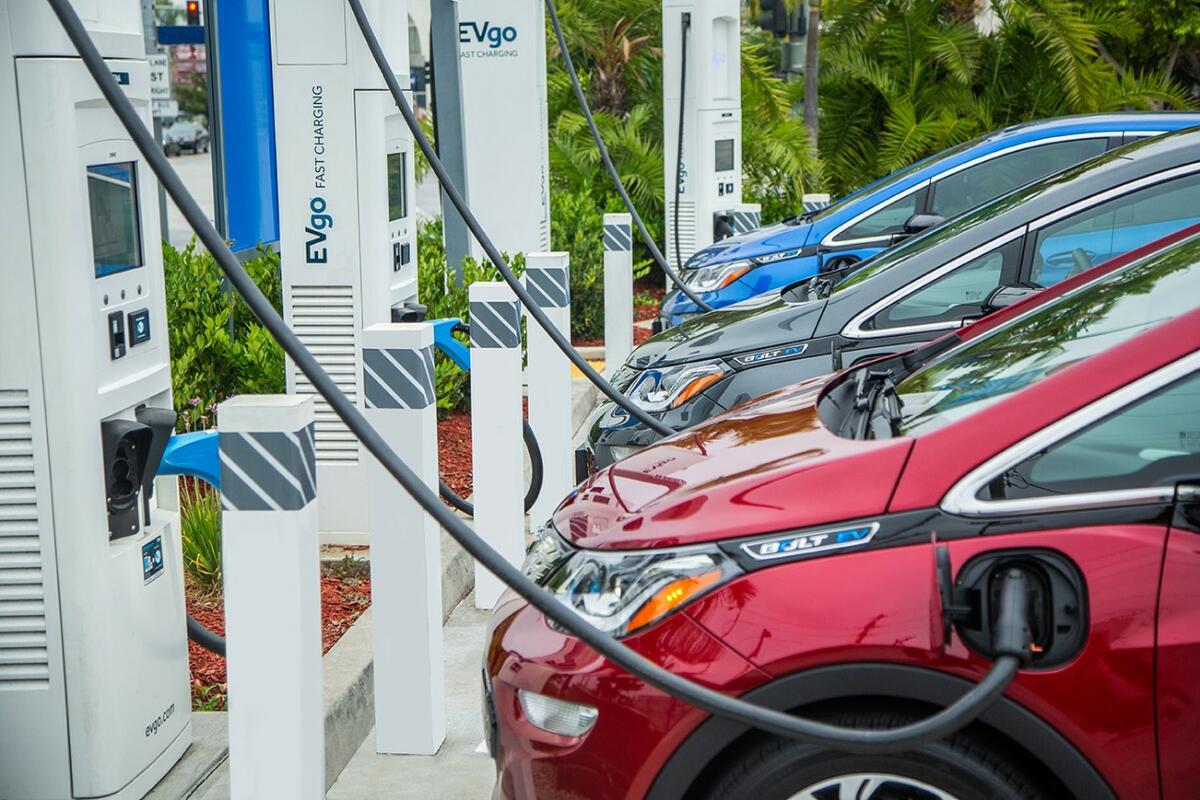 GM cars lined up at charging stations.