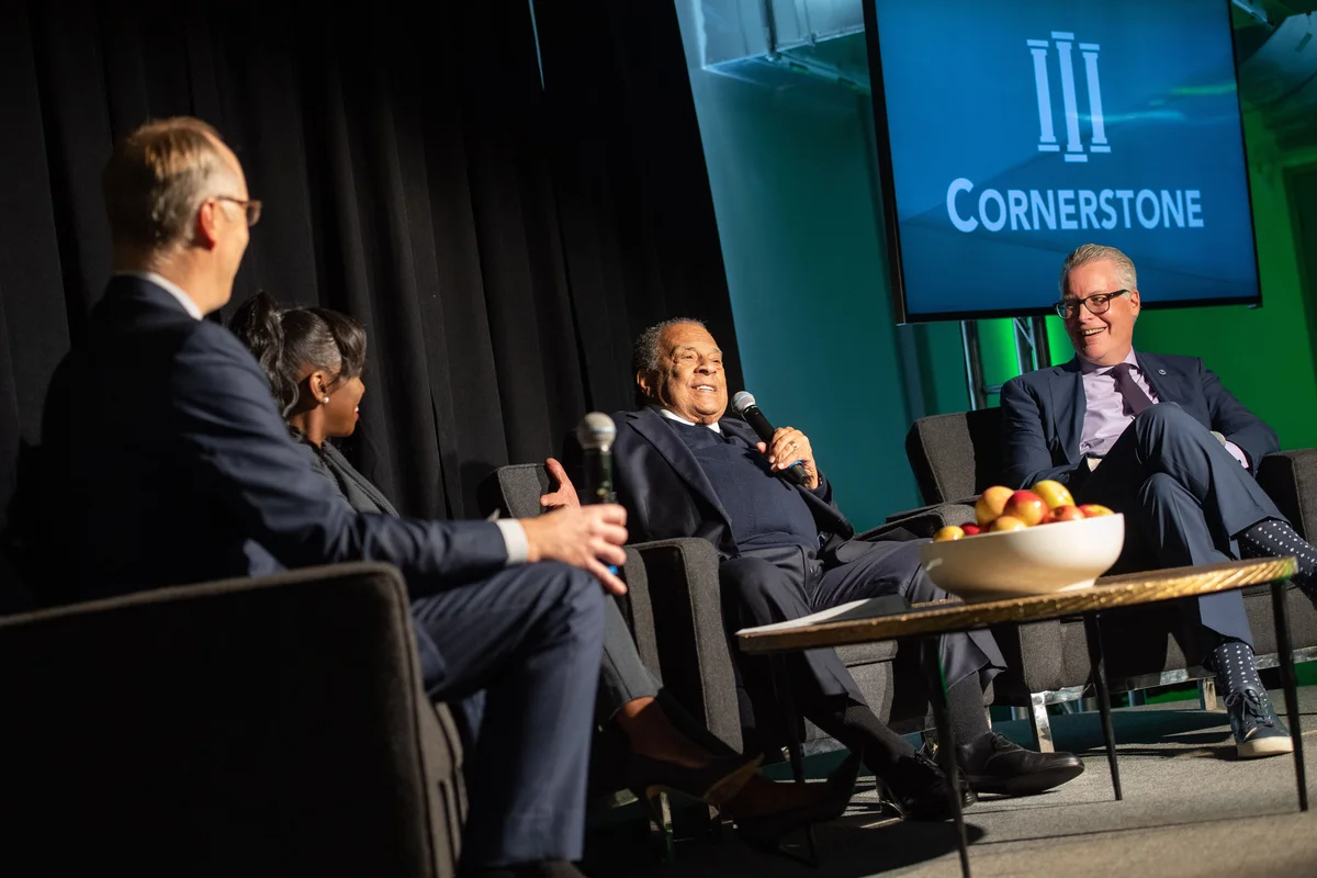 Ed Bastian sits with Ambassador Andrew Young and other Cornerstone School leaders during a ceremony surprising Young with a dedication of a Cornerstone facility in his name. 
