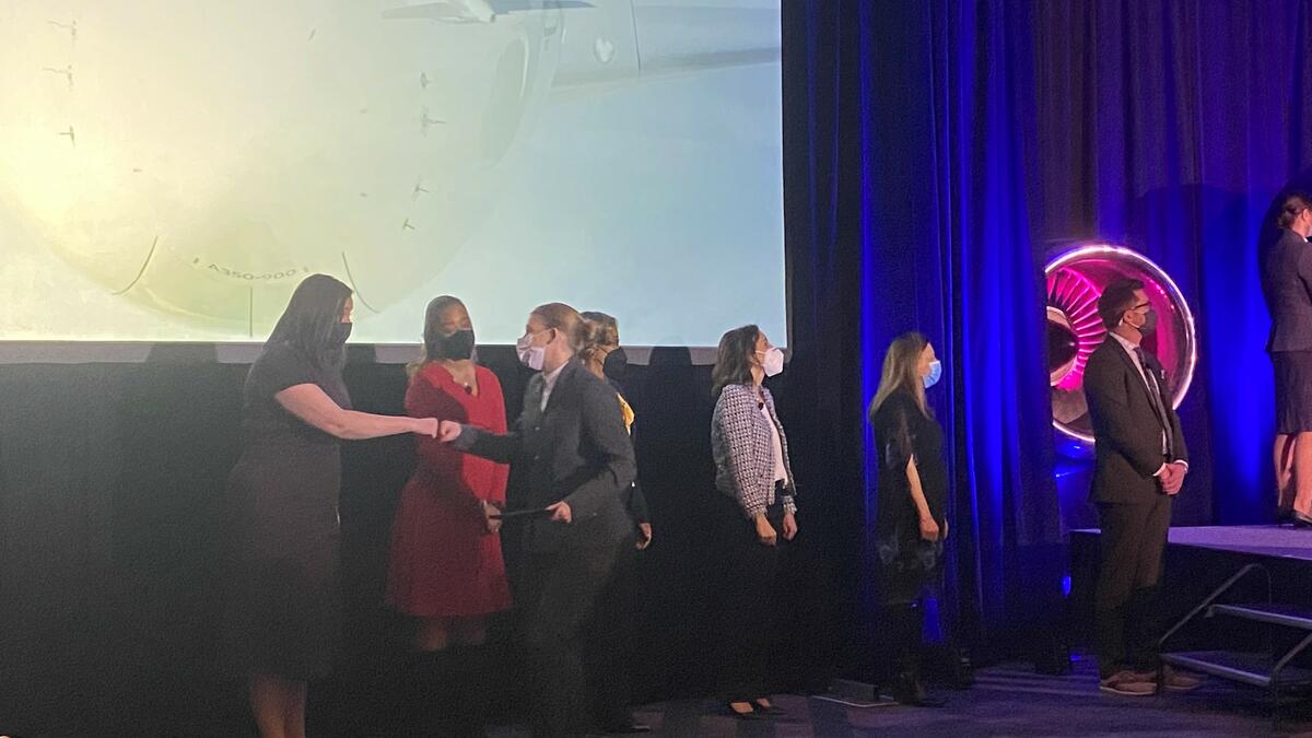 A flight attendant exchanges a fist bump after receiving her Delta wings.