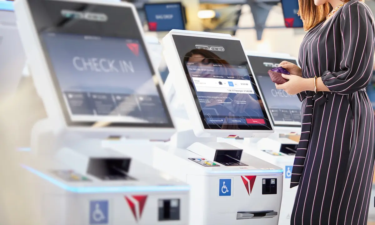 Customer checking in at a kiosk using their American Express card.