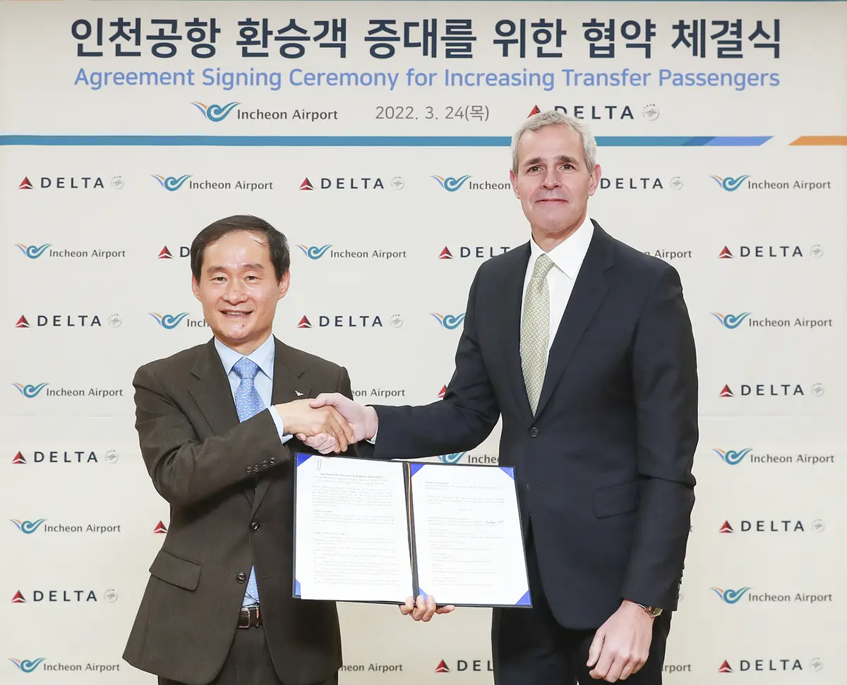 Officials pose for a photo after the Incheon airport agreement is signed.