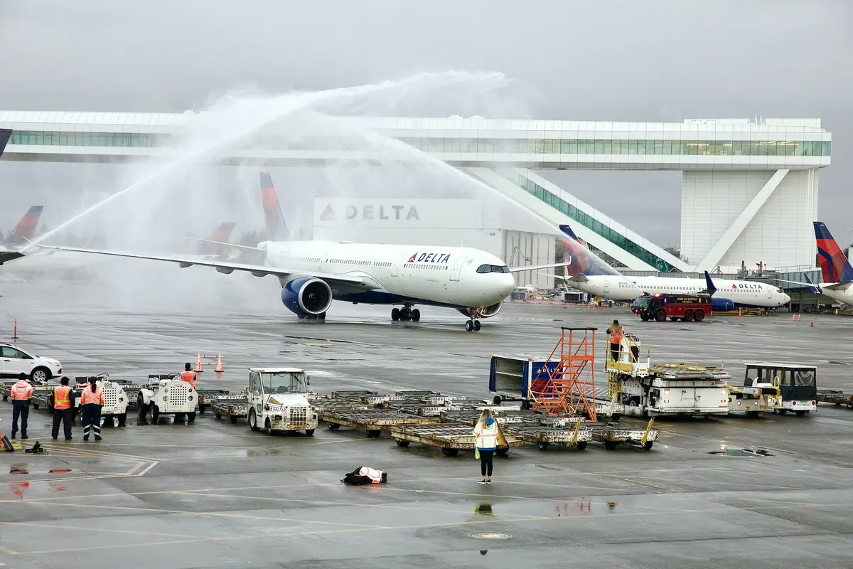 Greeted by a water turret salute, the Airbus A330-900neo touched down in Seattle just as the sun rose over the 85-foot-high aerial walkway at IAF, the largest in the world over an active taxi lane. 