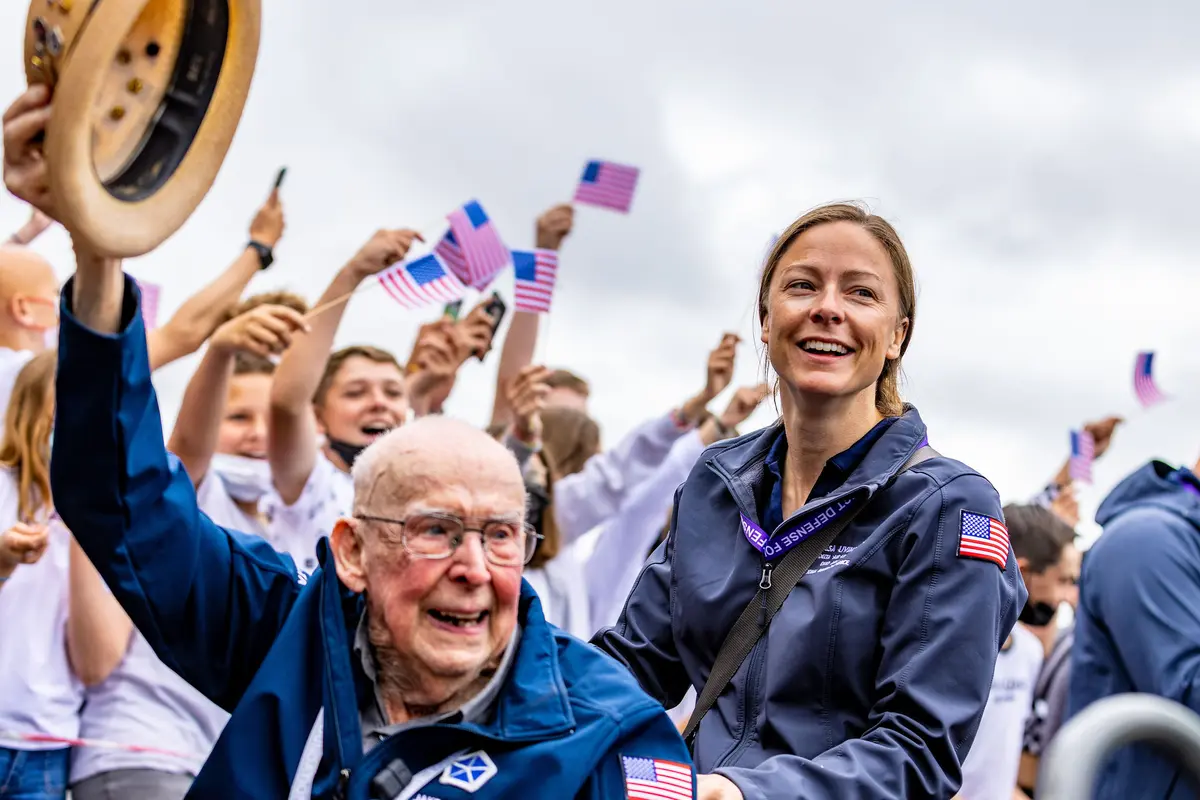 Delta’s Theresa Livingston escorts Jake Larson at a secondary school in Bayeux.