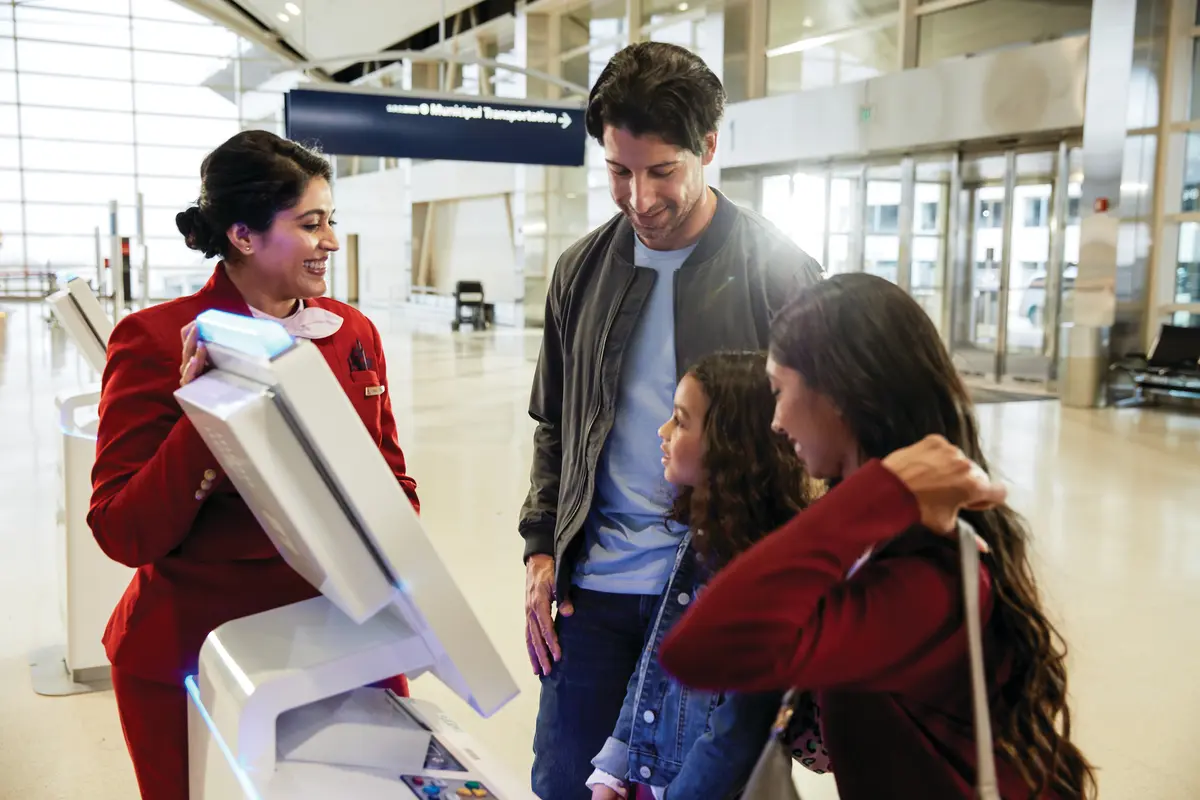 A family checks in with the help of a famous Delta Red Coat.