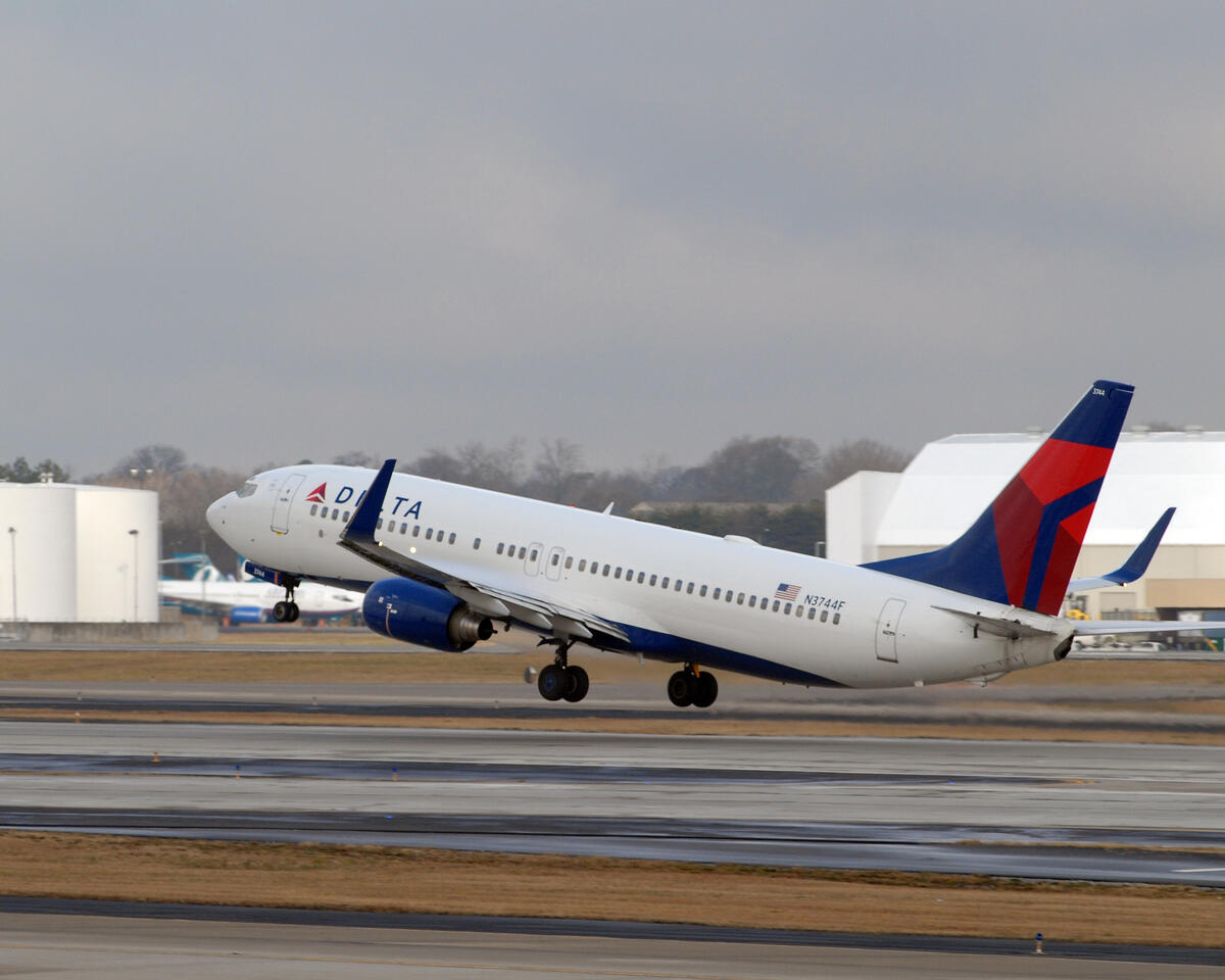 A 737-800 taking off into a gray sky.