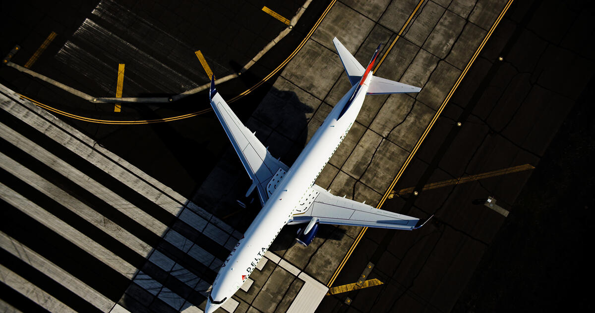 A 737-900 is captured on a runway with a full-body overhead view.