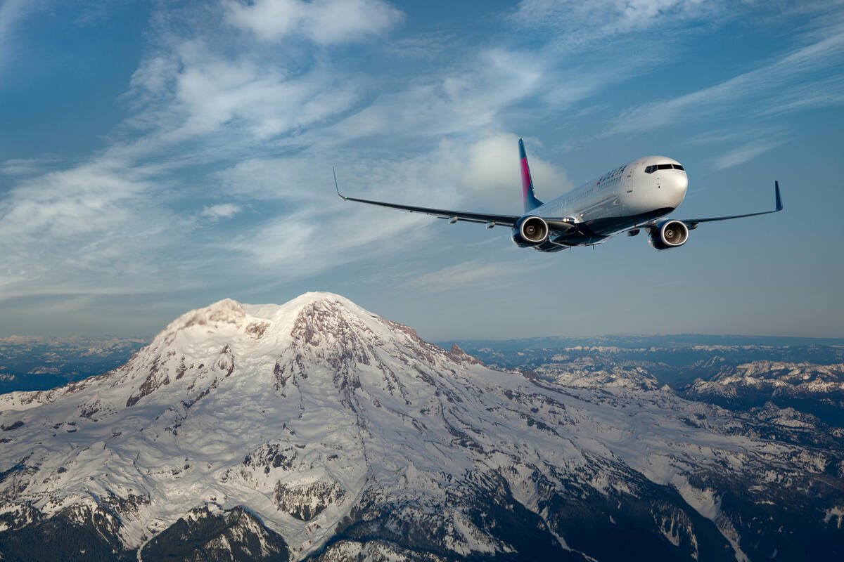 737-900 in flight over mountains