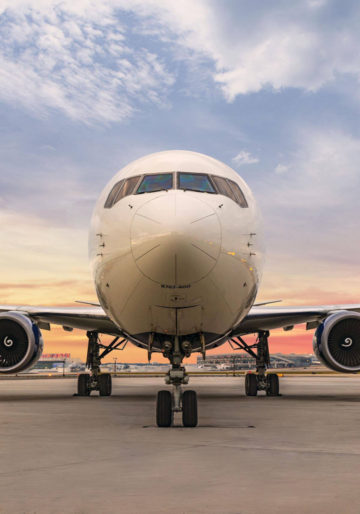 Delta's Boeing 767-400 stands forward facing with a gradient sky background. 