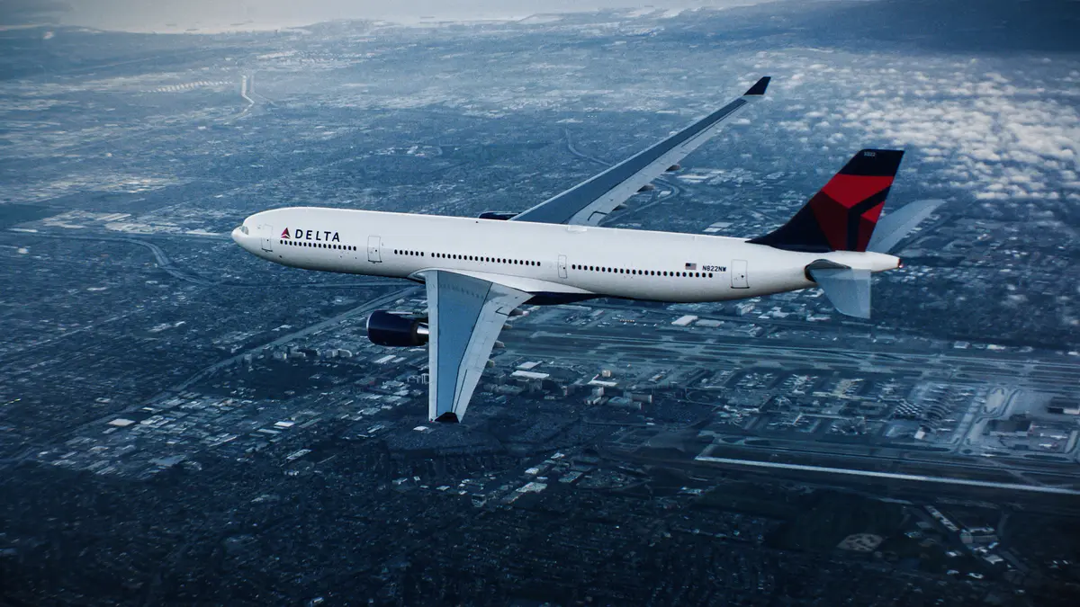 A330-300 in flight over city