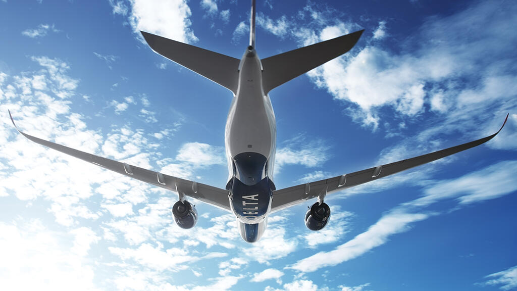 A350-900 in flight against clouds