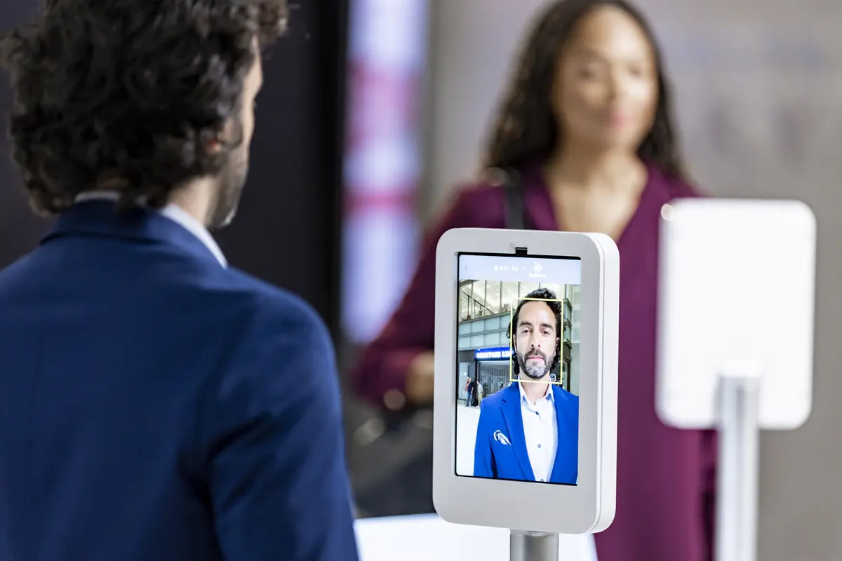 Male customer using Parallel Reality screen to check-in