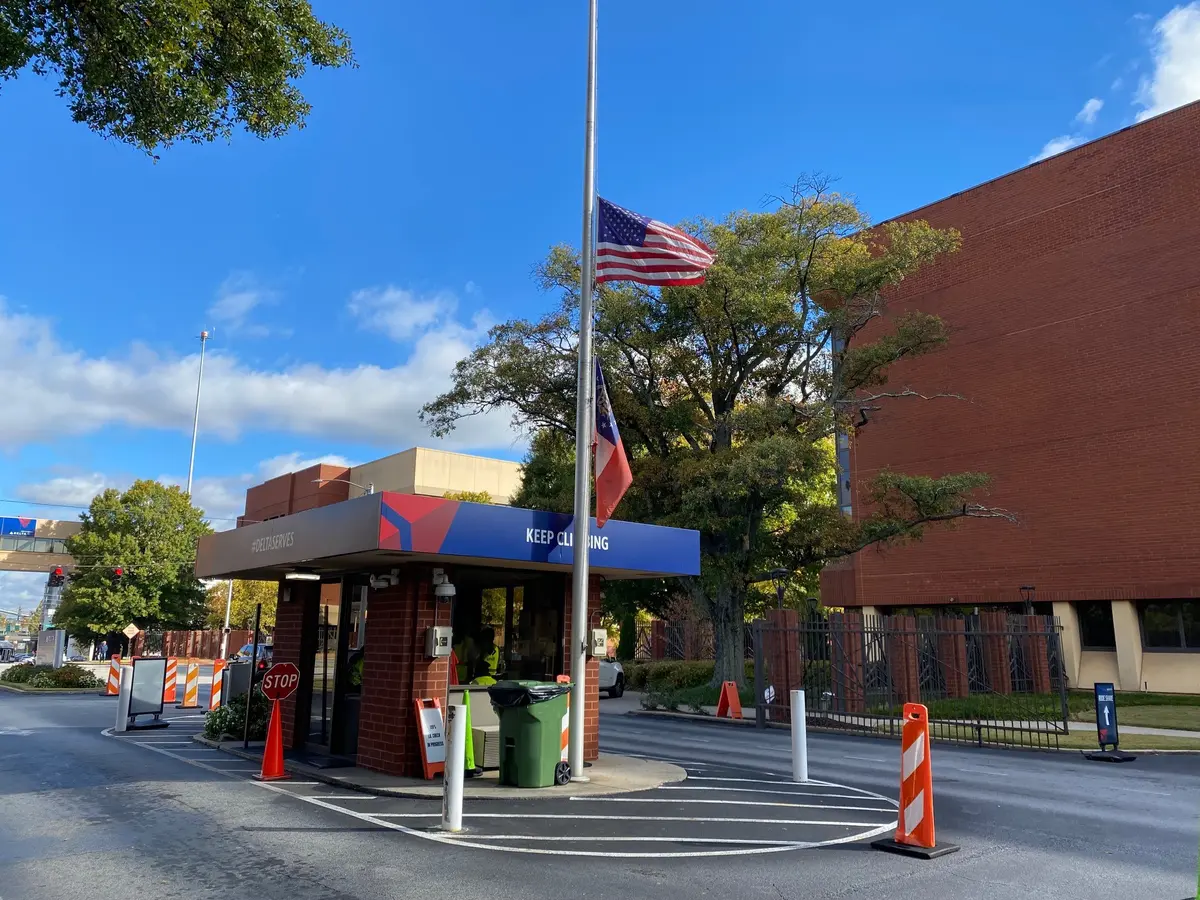 Flags are shown at half-staff at Delta's Atlanta headquarters on Wednesday, Oct. 26, 2022.
