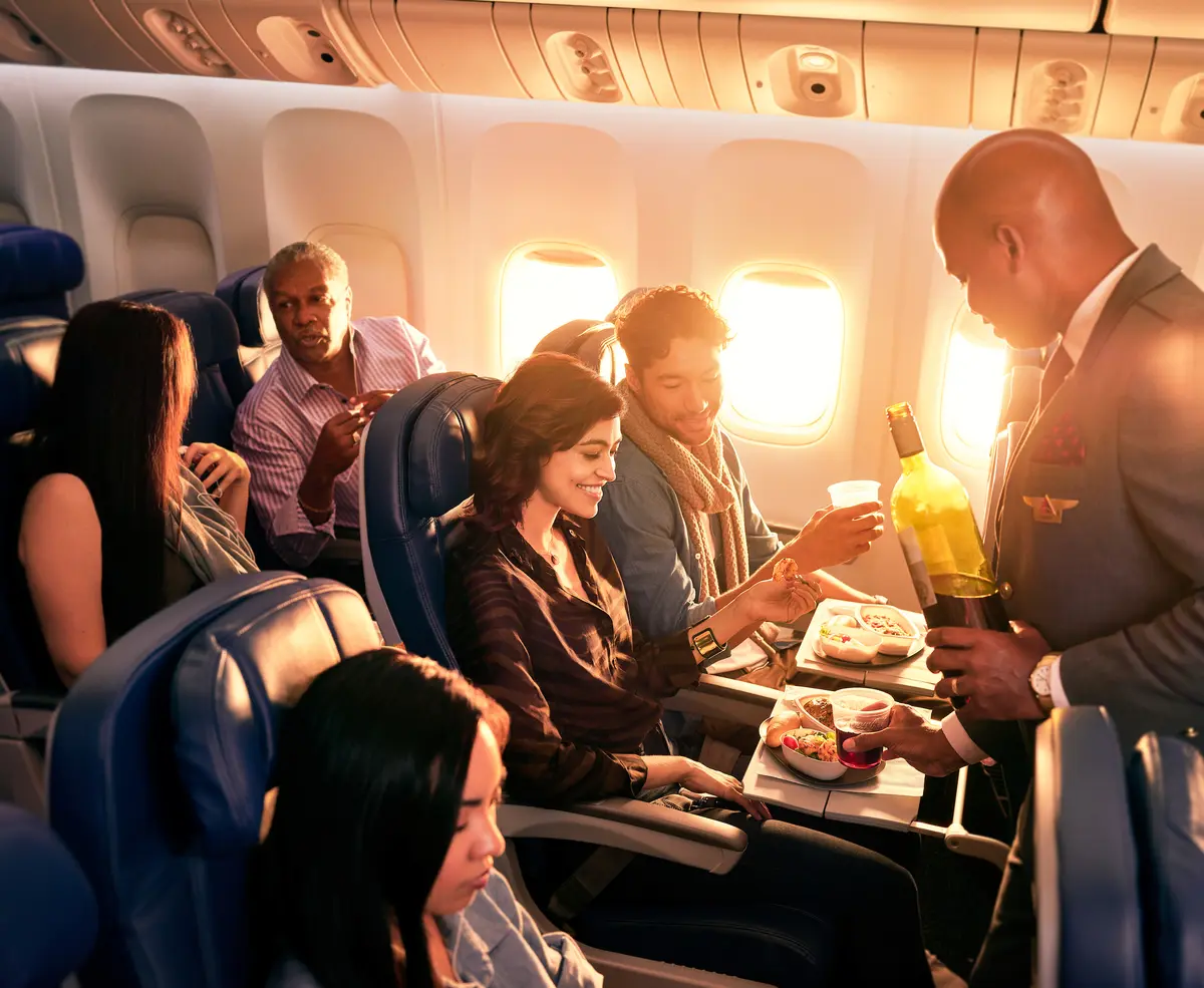 Delta Flight Attendant Robert F. serves customers on board.
