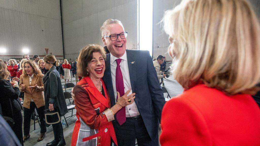 Ed Bastian and Barbara Dooley as the ceremony commemorating the life and legacy of renowned University of Georgia football coach Vince Dooley with the dedication of a Boeing 767-400 featuring a memorial seal honoring the Hall of Famer.  