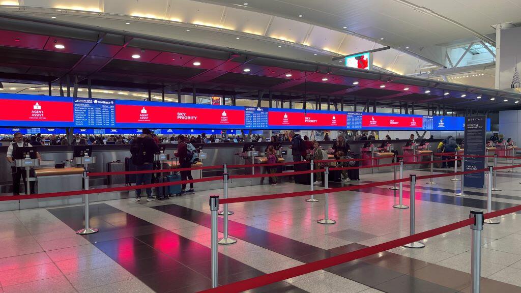 Delta’s signature digital backwall with up-to-date gate information at New York - JFK.