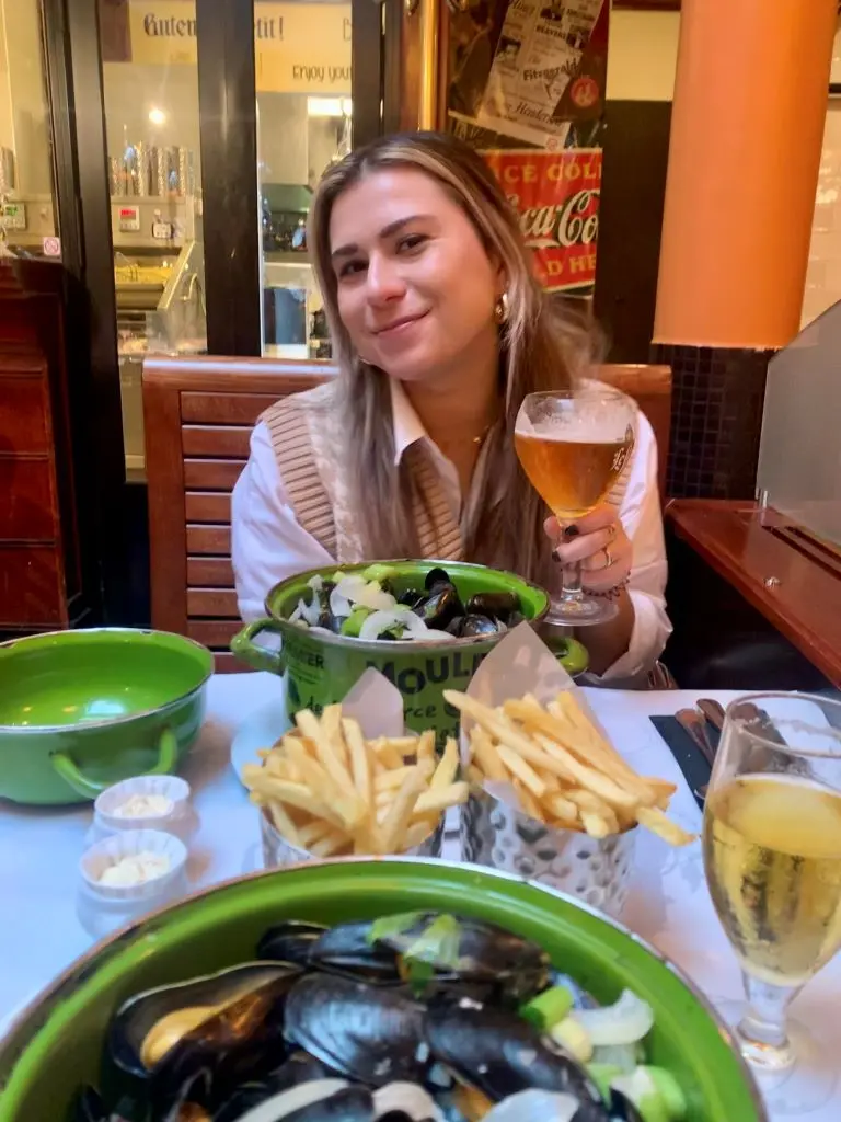 A Delta employee enjoys a meal of moules frites in Brussels