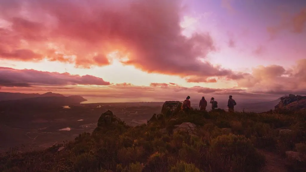 People on a mountaintop with a colorful sunset for Delta's new "Kaleidoscope" brand spot.