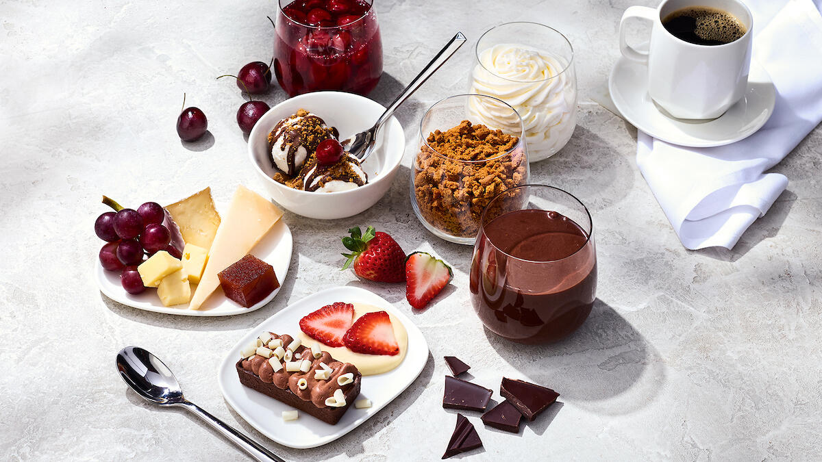 The Delta One dessert carts features a variety of treats like opera cake with chocolate ganache; Cowgirl Creamery wagon wheel, Midnight Moon gouda, and grapes.