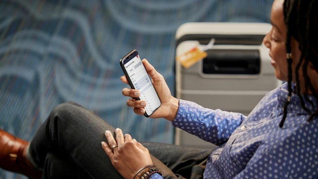 A Delta customer uses the Fly Delta app to view their flight.