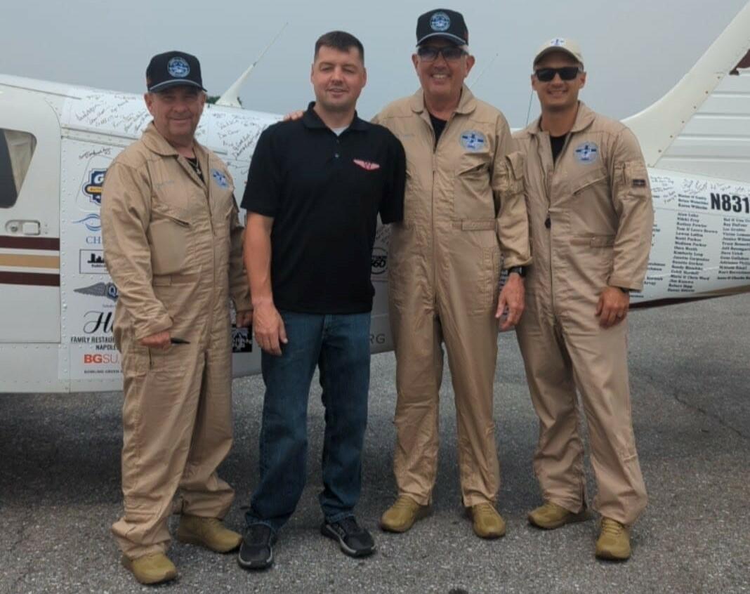 The members of the 48N48 mission pose with Adam Kisielewski, a combat-wounded veteran and member of the Veterans Airlift Command advisory board, during their stop in Maryland.