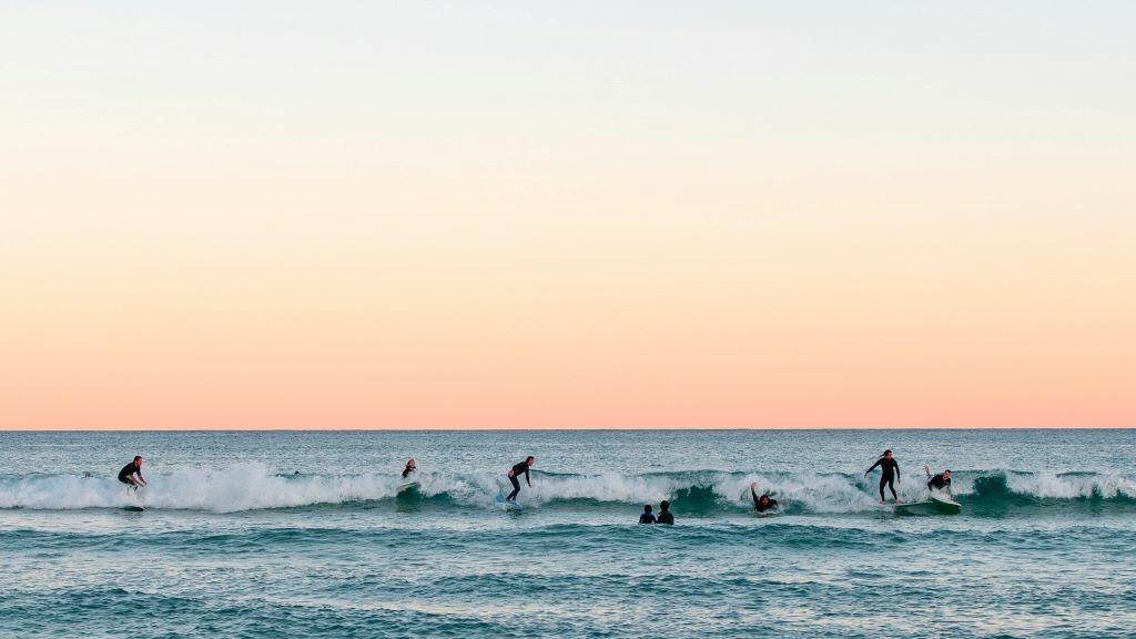 Surfers catch waves at Bondi Beach in Sydney, Australia