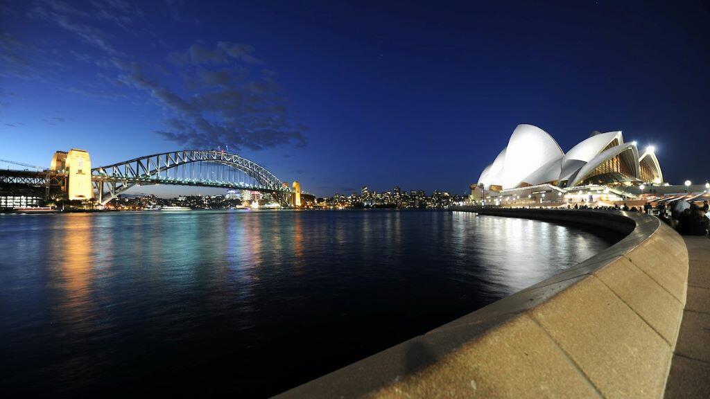 A nightime view of the Sydney Harbour Bridge and Sydney Opera House