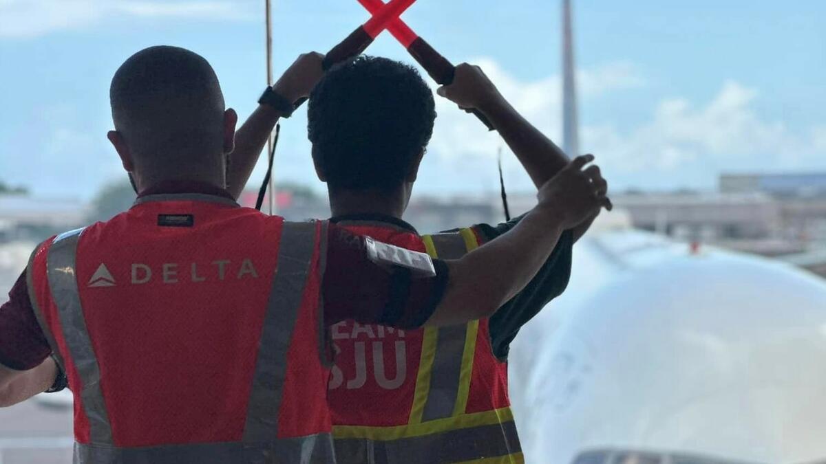 A Delta employee works with a child at San Juan Airport as part of a special initiative to inspire excitement about aviation.