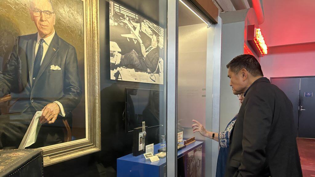 A Delta Flight Museum employee walks Todd O., Delta's most frequent flyer, through the aviation capsule collection featuring founder C.E. Woolman’s most treasured belongings. 