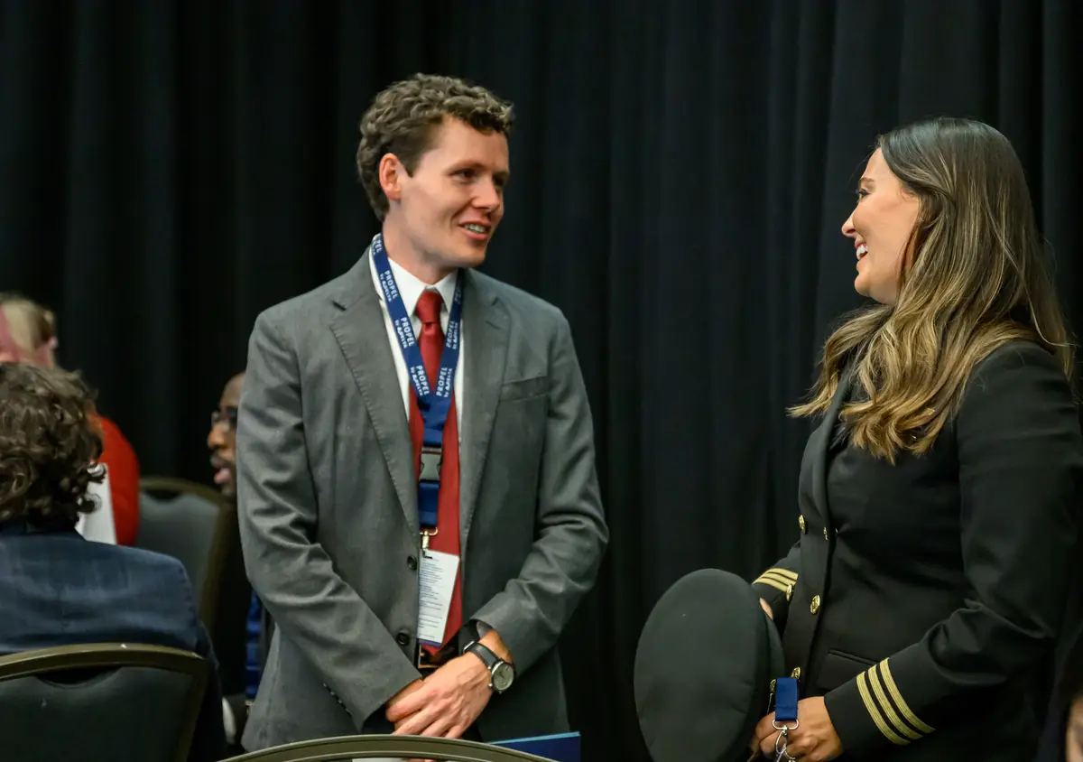 Delta employee Michael Hulse speaks with Samantha Warren, a Delta pilot and the very first Propel Company graduate.