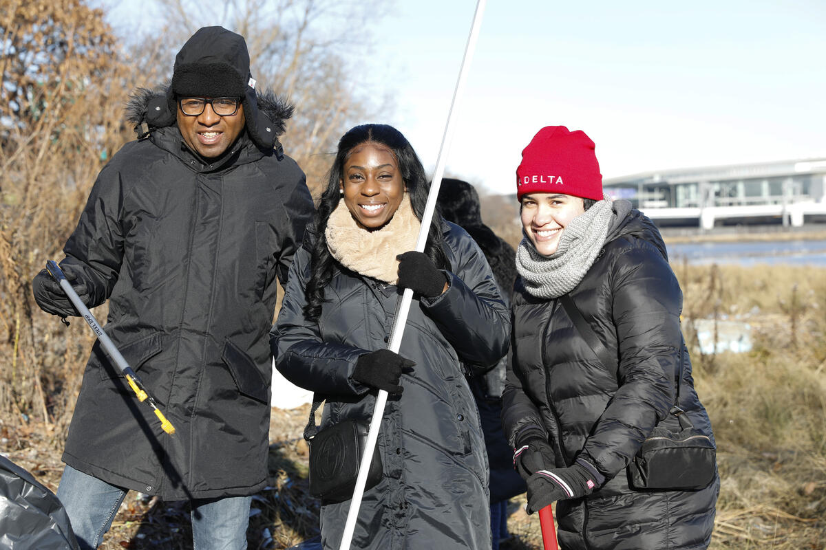 Queens Borough President Donovan Richards joins Delta people in clean up event at Flushing Meadows Park on MLK Day.