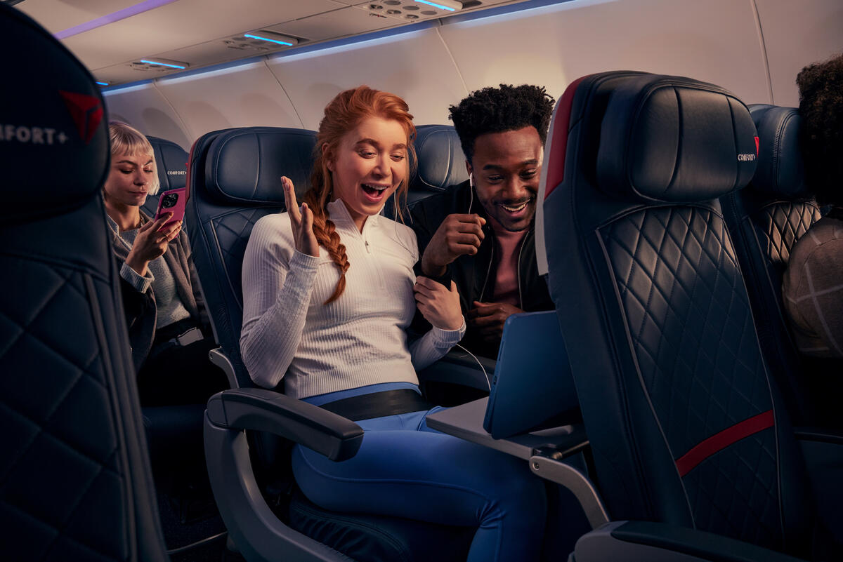 Delta customers watch a tablet on-board using Delta's fast, free Wi-Fi.