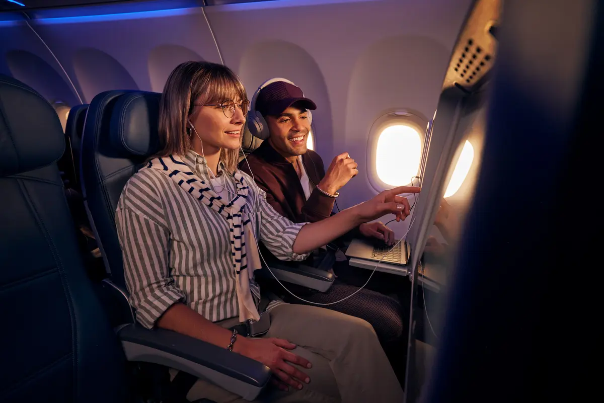 Customers browse seatback entertainment on a Delta flight.