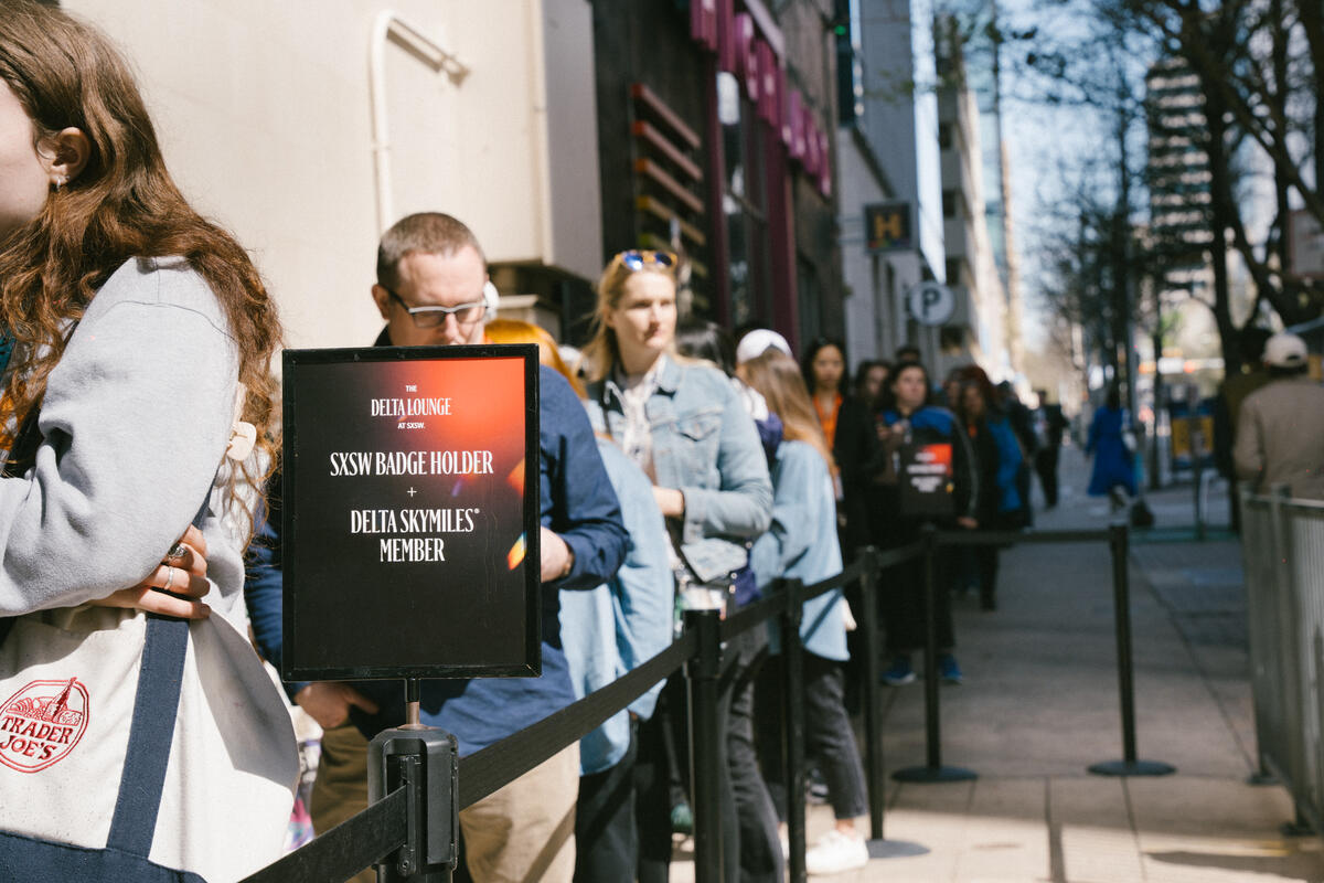 Visitors eagerly wait to enter the Delta Lounge, a branded pop-up experience exclusively for SkyMiles members featuring fast, free Delta Sync Wi-Fi, global fan-favorite beverages from Delta partner Starbucks, custom limited-edition Delta x SXSW merch, and more.  