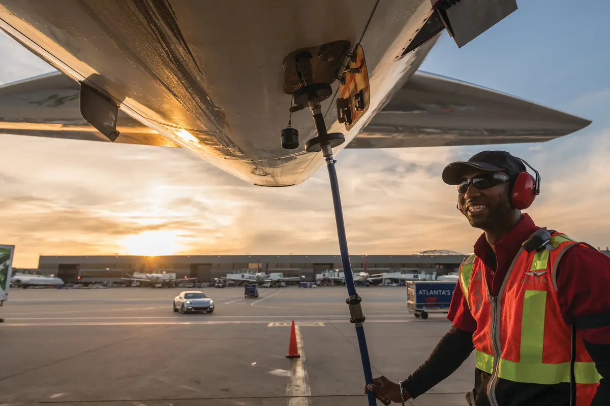 Ramp agent working under an aircraft